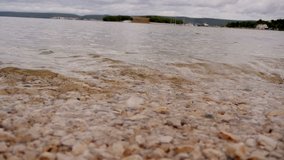 small sea waves hitting pebble shore in slow-motion HD