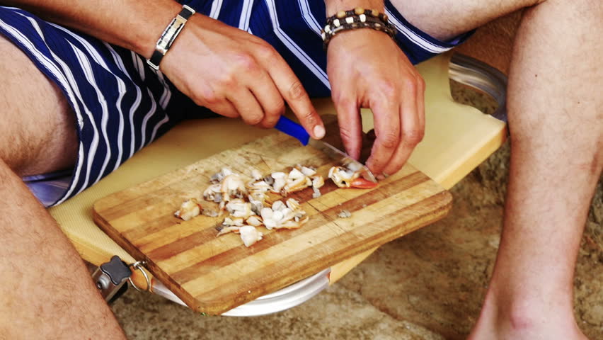 Fisherman preparing shellfish baits onto parangal hooks for fishing slow-motion HD