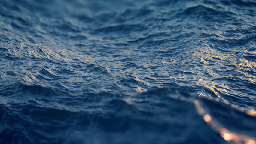 Slow motion close up of  disturbed blue ocean water surface. Nice looping background (4K,ultra high definition 2160p, seamless loop), slow motion
