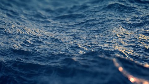 Slow motion close up of  disturbed blue ocean water surface. Nice looping background (4K,ultra high definition 2160p, seamless loop), slow motion
