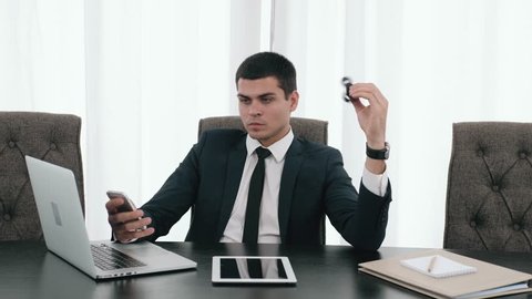 Businessman with a spinner toy, confident director with spinner, business man with laptop and tablet in modern office relax with spinner toy