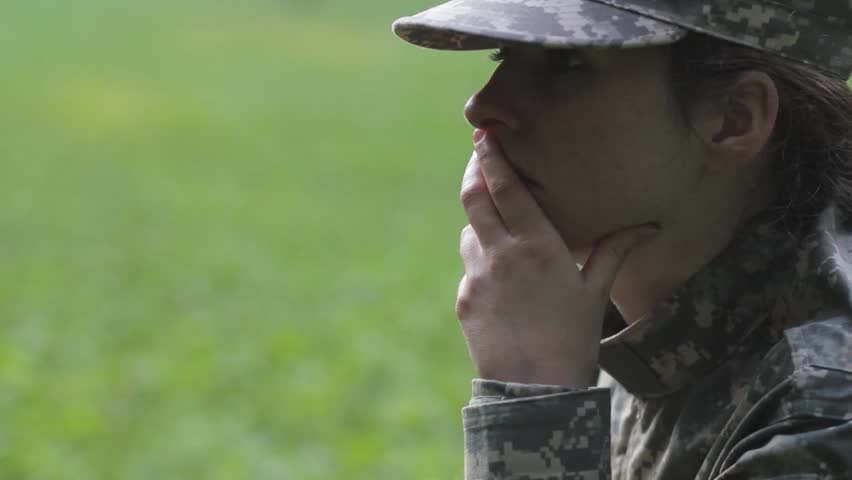 Woman soldier deep in thought
