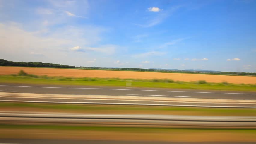 Car driving through countryside on the highway
