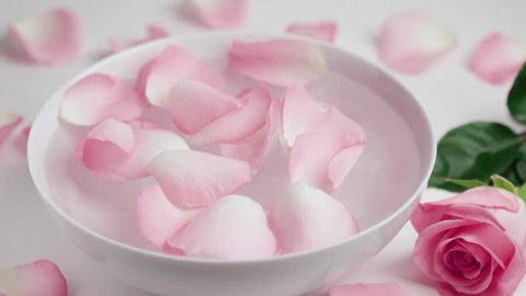 Rose Petals falling into bowl Slow motion