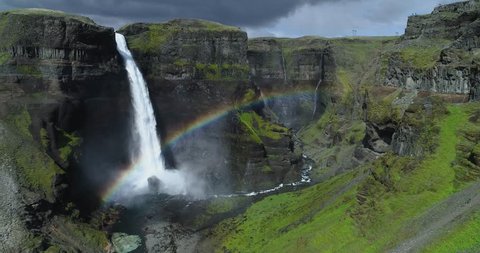 Aerial View of a Rainbow in front of a Waterfall Stockvideo
