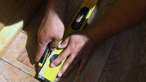 the worker cuts off the linoleum with a utility knife,fitting of linoleum floor.