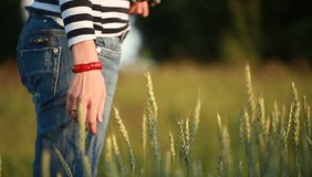 Video girl is walking along wheat rye oat field mixed planting