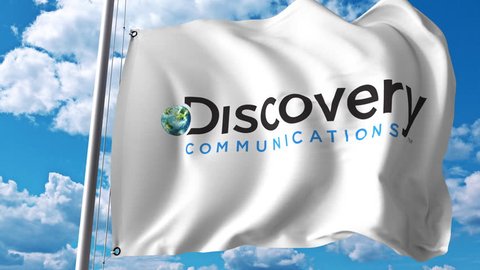 Waving flag with Discovery Communications logo. 4K editorial animation