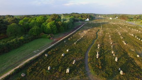Flying over the famous "Alignements de Carnac" located in Carnac, Morbihan, Brittany, France. Sunset on the Megaliths of the Menec, one of the largest Megalithic complex in the world.