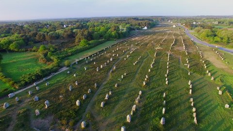 Flying over the famous "Alignements de Carnac" located in Carnac, Morbihan, Brittany, France. Sunset on the Megaliths of the Menec, one of the largest Megalithic complex in the world.