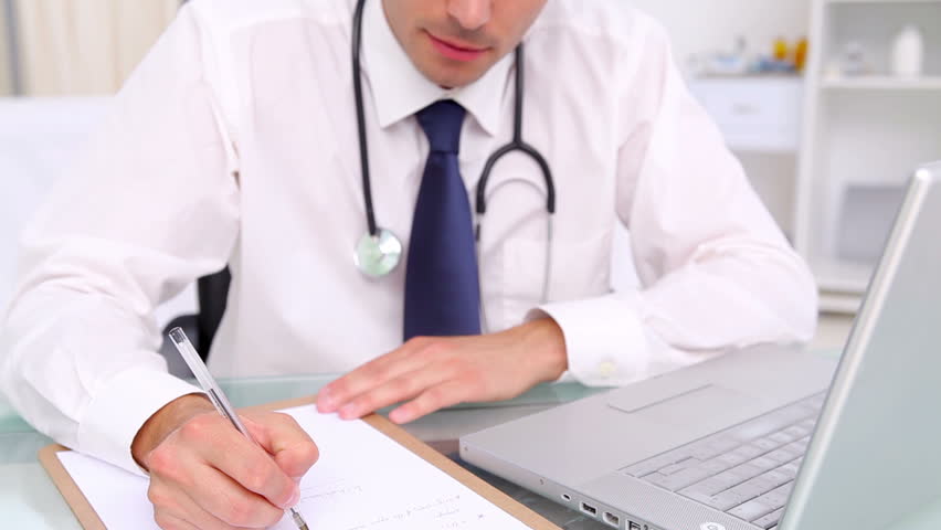 Smiling practitioner writing on his clipboard in his office , Healthcare workers in the Coronavirus Covid19 pandemic | Shutterstock HD Video #2903722