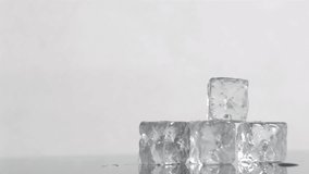 Trickle of water in a super slow motion flowing on ice cubes and faliing it against a white background - Powered by Shutterstock - Get 15% off with code: PIKWIZARD15