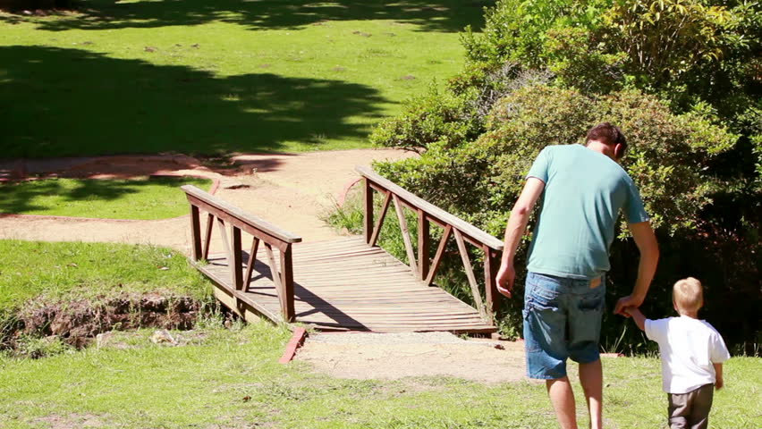 Man walking with his little boy in a park