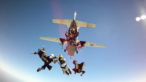 Skydiving Exit from airplane in blue sky