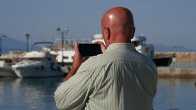 Tourist Agent Take Photos Using Cellphone in a Harbor for a Travel Agency (Ultra High Definition, UltraHD, Ultra HD, UHD, 4K, 3840x2160)