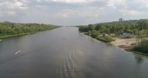 Ukraine. Kiev. July 21, 2017. Truhanov Island. Aerial photography. 4K video. River Dnieper. Forest. Trees. Summer. Sunny weather. The sun. Kayaks. Sport. Training. People. Water. Canoe. Sky.