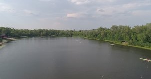 Ukraine. Kiev. July 21, 2017. Truhanov Island. Aerial photography. 4K video. River Dnieper. Trees. Summer. Sunny weather. The sun. Kayaks. Sport. Training. People. Water. Canoe. Sky.
