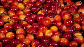 Amazing water flowing and splashing red and yellow cherry berries in slow motion. Shooting with high-speed, 240fps, camera. Flat lay of yummy fresh fruit with amazing texture in full HD clip.