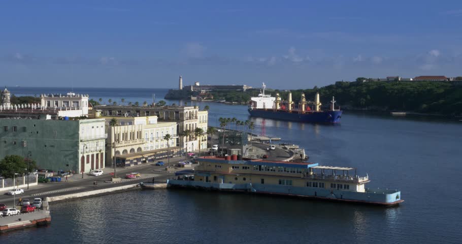 A large freighter cargo ship pulls into Havana Port Bay in Cuba.  	