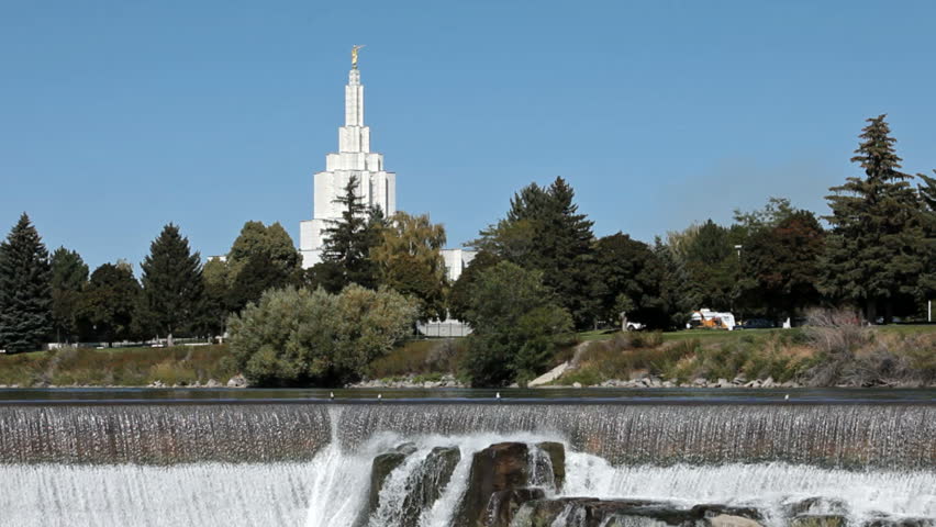 Idaho Falls Temple of the Church of Jesus Christ of Latter-Day Saints, Mormon or LDS. On Snake River with waterfalls and parks. Traffic along river.