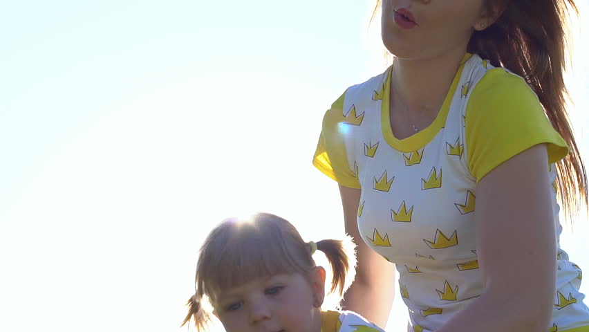 Beautiful family in park. Sun light, sunny day. Slow motion.