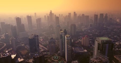Aerial view of cityscape of Jakarta with skyscrapers at dusk time, shot in 4k resolution