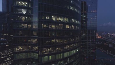 A night drone Aerial shot of skyscrapers of  business centre city, 4K Ultra HD real time video. Urban scene of consulting company office. Camera moving around building. Moscow skyline