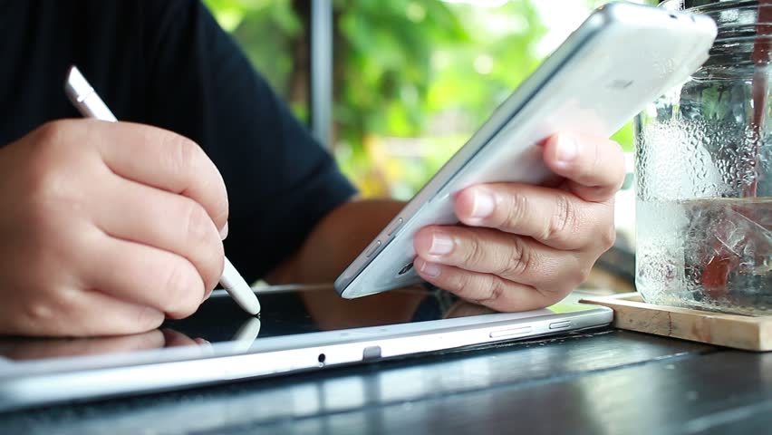 Using Online banking payment by network technology internet on wireless development mobile smartphone and tablet sync app with touch pen for Business  holding smart phone for shopping coffee shop | Shutterstock HD Video #29075518