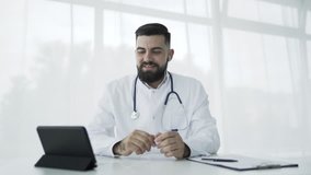 Doctor using tablet pc in office to video chat. 4K