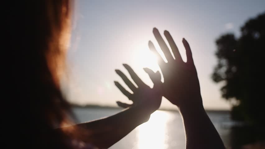 Sun in hands. Woman hand catching a sun against beautiful sunset on horizon.  | Shutterstock HD Video #29079739
