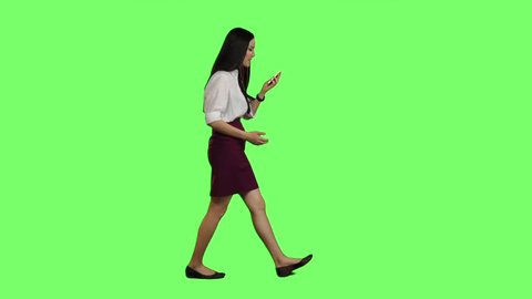 Girl is going to an important meeting, talking on the phone, she is angry. Green screen. Slow motion