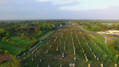 Flying over the famous "Alignements de Carnac" located in Carnac, Morbihan, Brittany, France. Sunset on the Megaliths of the Menec, one of the largest Megalithic complex in the world. 