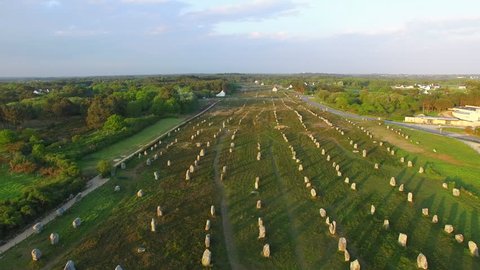 Flying over the famous "Alignements de Carnac" located in Carnac, Morbihan, Brittany, France. Sunset on the Megaliths of the Menec, one of the largest Megalithic complex in the world. 