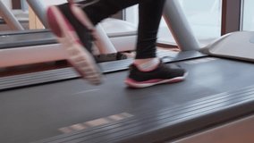 Young girl trains on a treadmill in the gym stock footage video