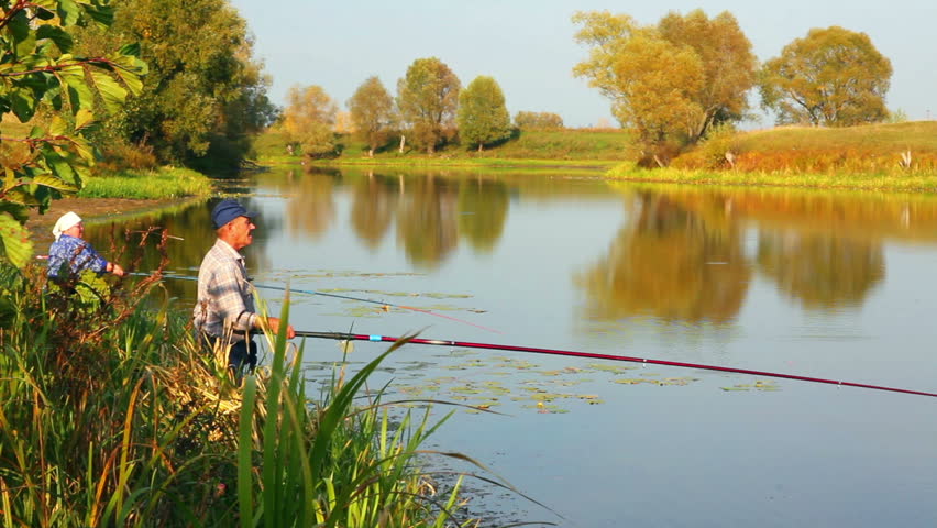 fishing senior couple on autumn lake