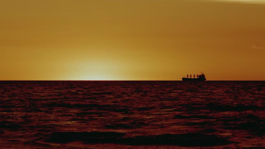 The boat sails at sunset