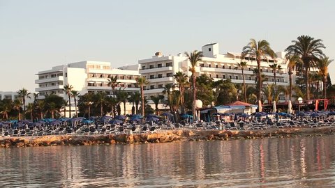 Morning on the sea beach, a series of hotel buildings on the seashore, an empty beach by the sea, sun loungers and sun umbrellas on a sandy beach, the exterior of a modern hotel on the beach 
