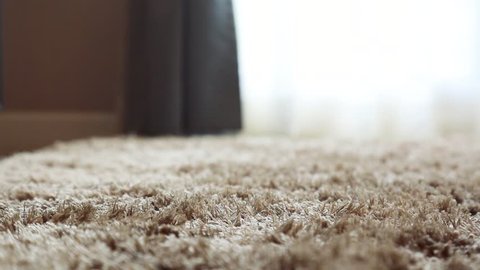 Synthetic carpet on the laminate in the home interior. Close-up