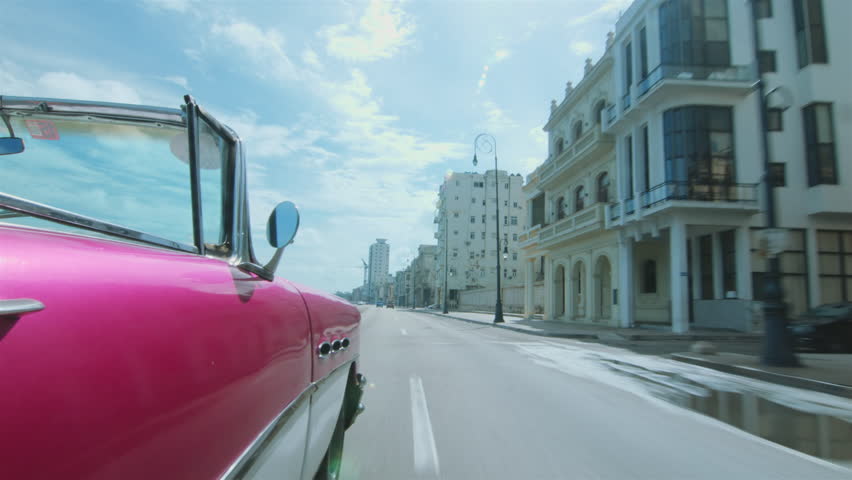 Cuban chauffeur driving through Havana, Cuba. Royalty-Free Stock Footage #29114680