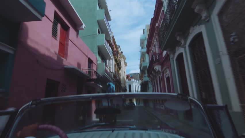 Cuban chauffeur driving through Havana, Cuba. Royalty-Free Stock Footage #29114686