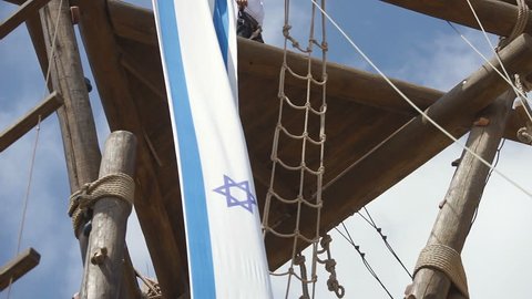 Israel flag hanged on wooden tower waving in the wind