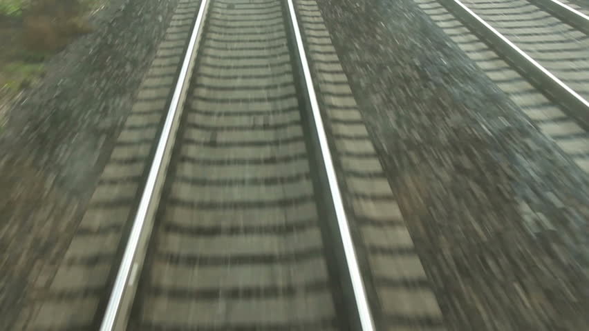train passing through countryside, moving railroad tracks