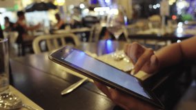 woman use digital tablet in restaurant close up shot 4K stock video