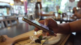 woman use smartphone in restaurant close up shot 4K stock video