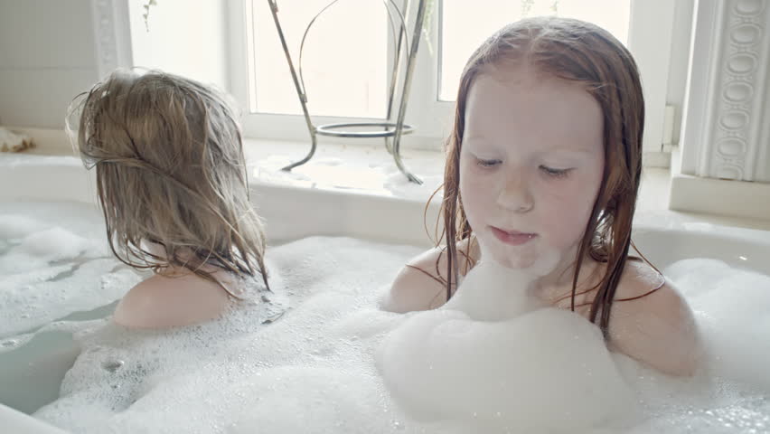 Teen girl bathing under shower stock photo