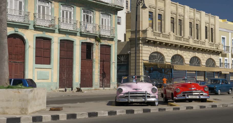 HAVANA, CUBA - Circa July, 2017 - A daytime establishing shot of vintage classic cars on the streets of Havana, Cuba.  	