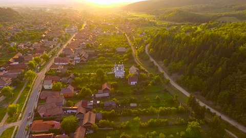 fly over Romanian village. aerial view. sunset. Romania, Covasna, Transylvanya