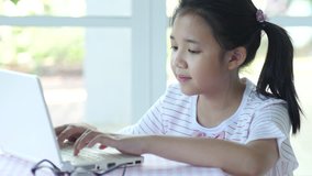 Close up of cute asian children using laptop