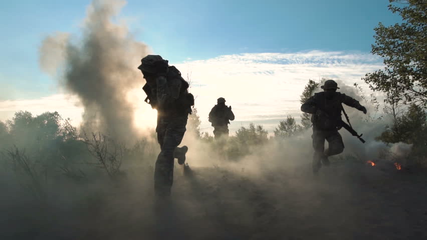 Slowmotion of silhouettes group of military men running on field in smoke and falling killed. Under mortar shelling