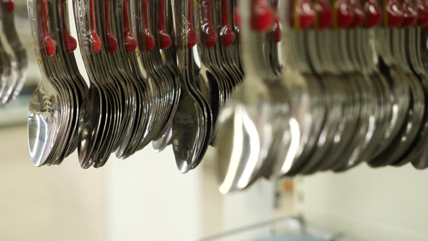 4k. Slow motion. Spoons on the counter in the supermarket close-up.